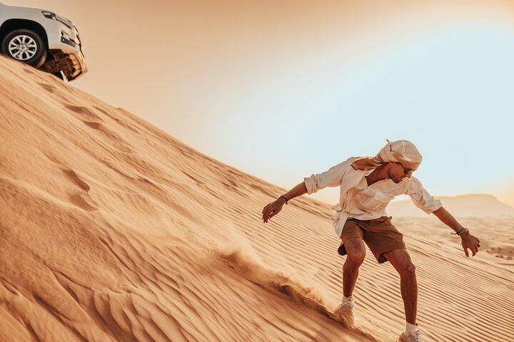 Experience the excitement of sand surfing down golden dunes surrounded by the stunning desert landscape where adventure awaits at every turn with the Adrenaline combo in Dubai.